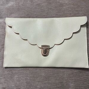 Women’s beige scalloped leather clutch